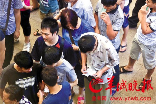 挎腰包的“黃牛”分發(fā)一輪“任務(wù)”后，自己也開(kāi)始整理“炒號(hào)”簽條